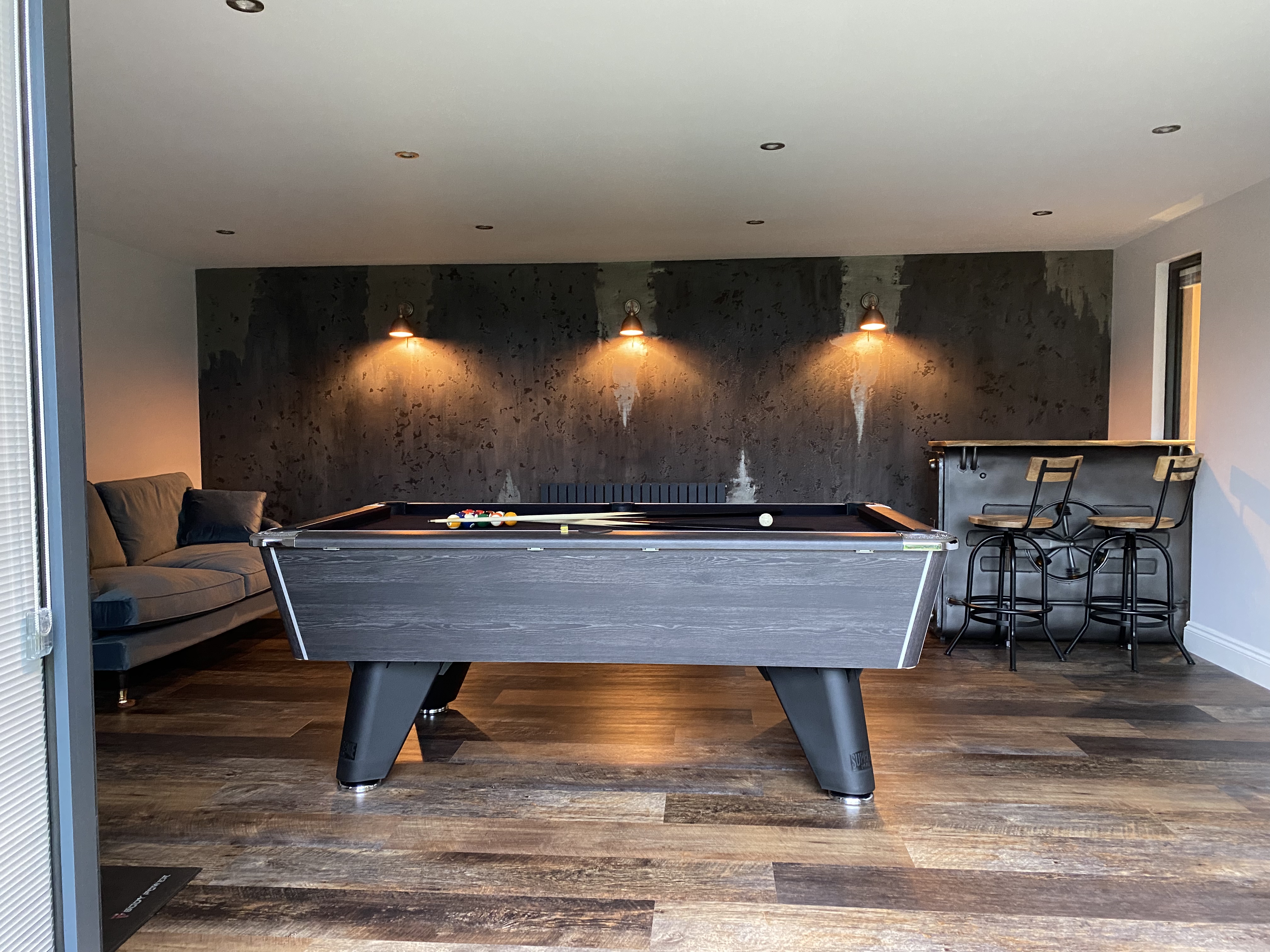 concrete venetian plaster billiards table and bar in garden studio horsham